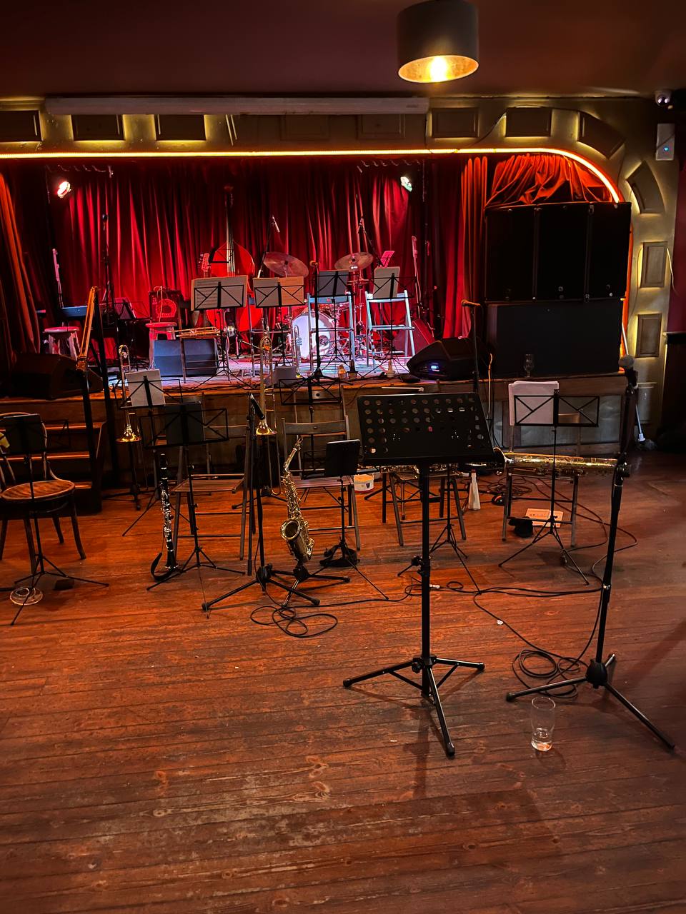 Stage in Crane Lane, set up for a big band, with rows of chairs for trombones and saxes below the stage