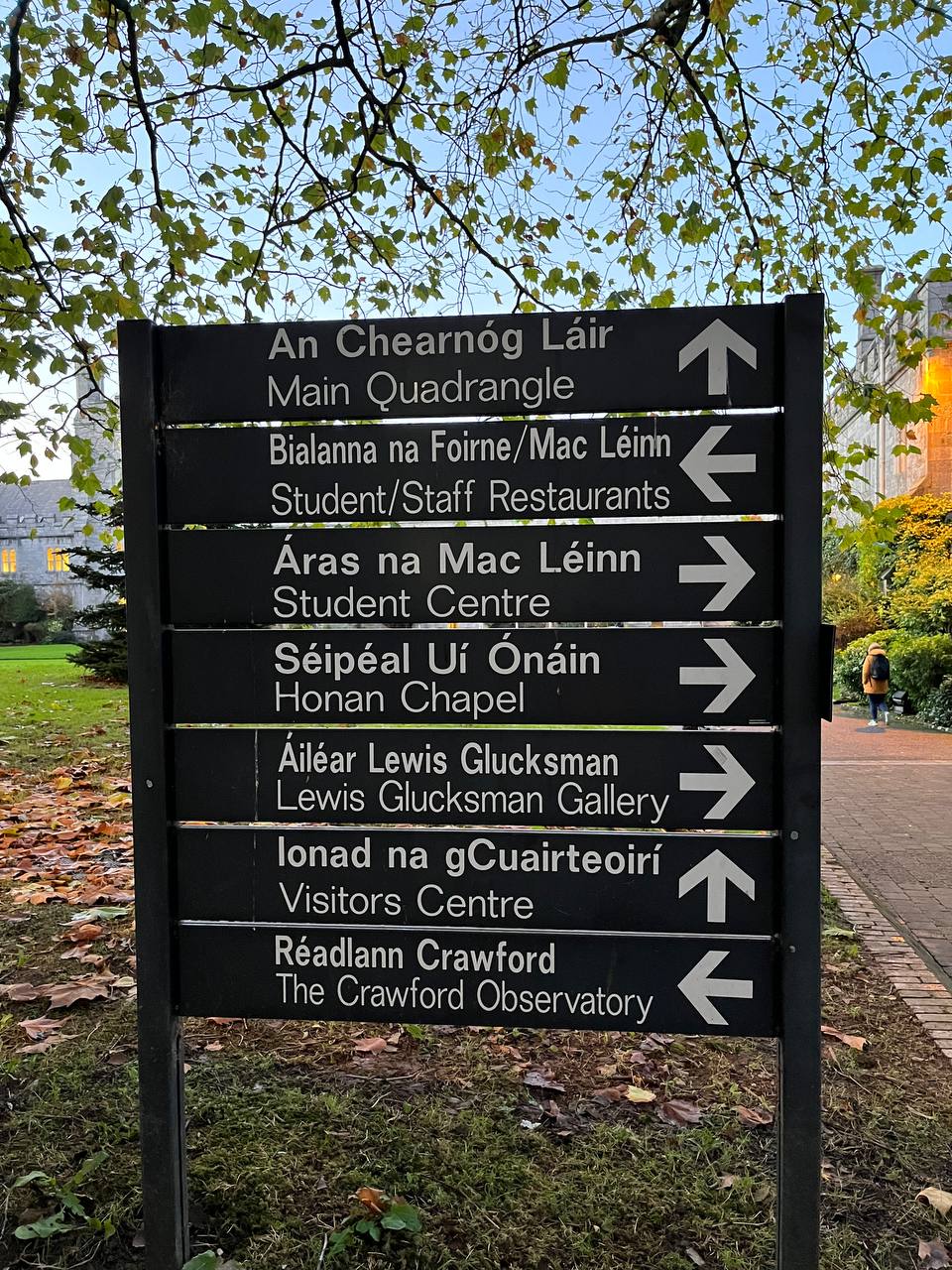 A sign with bilingual directions from the UCC campus